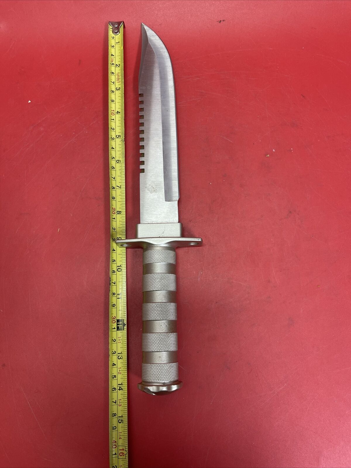 Knife with compartment in handle 8 1/2" blade and Saw type blade on the spine