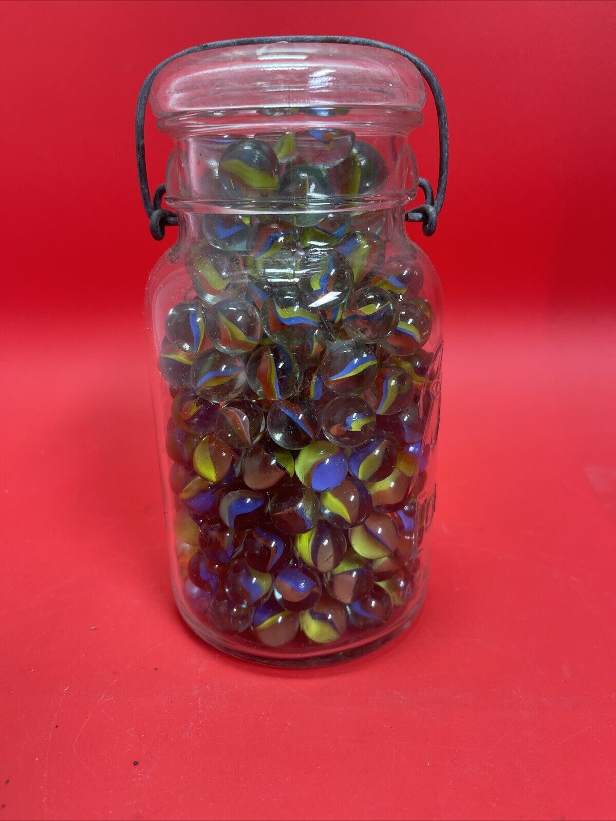 Vintage  Glass Ball Ideal Jar Filled With Marbles.  Jar Is 7” Tall.