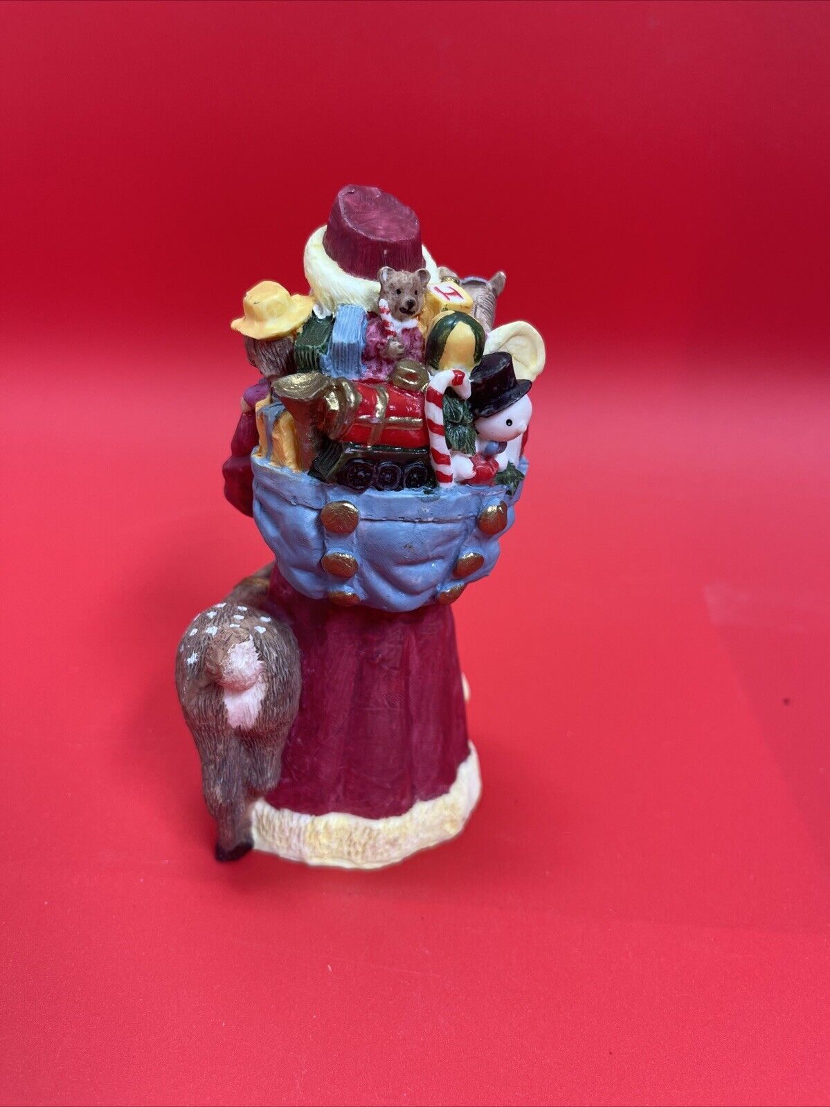 Santa Claus figurine with reindeer, duck and bag of gifts