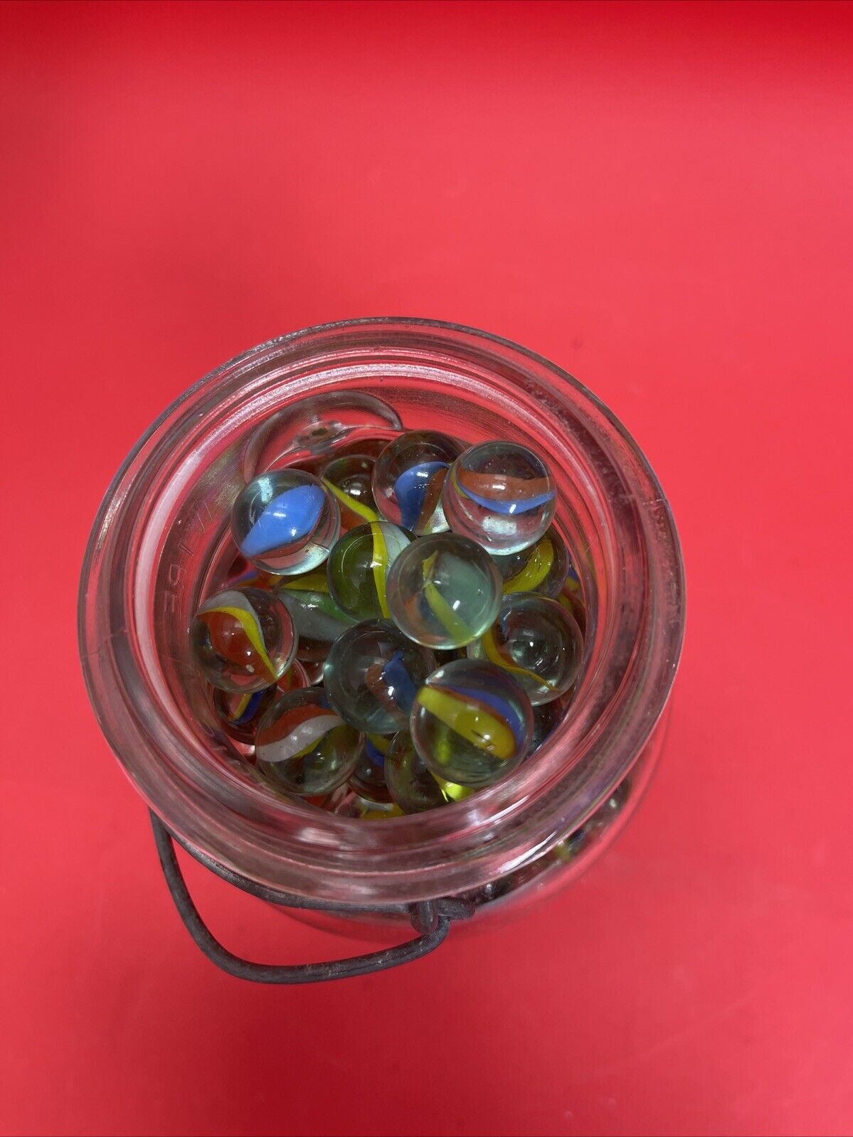 Vintage  Glass Ball Ideal Jar Filled With Marbles.  Jar Is 7” Tall.