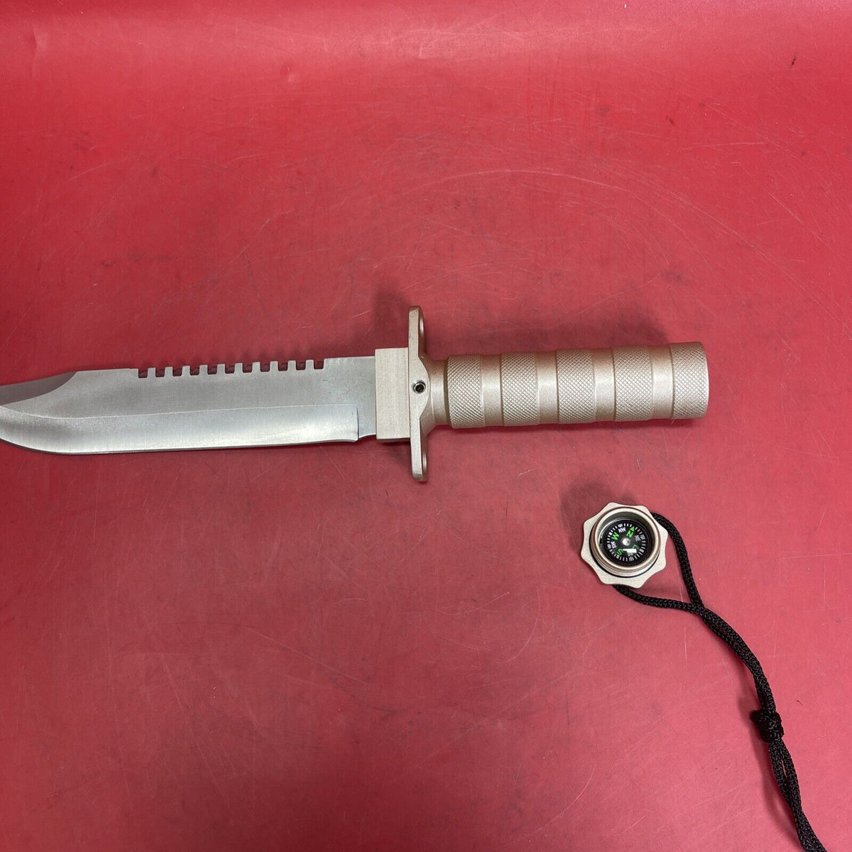 Knife with compartment in handle 8 1/2" blade and Saw type blade on the spine