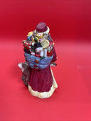 Santa Claus figurine with reindeer, duck and bag of gifts