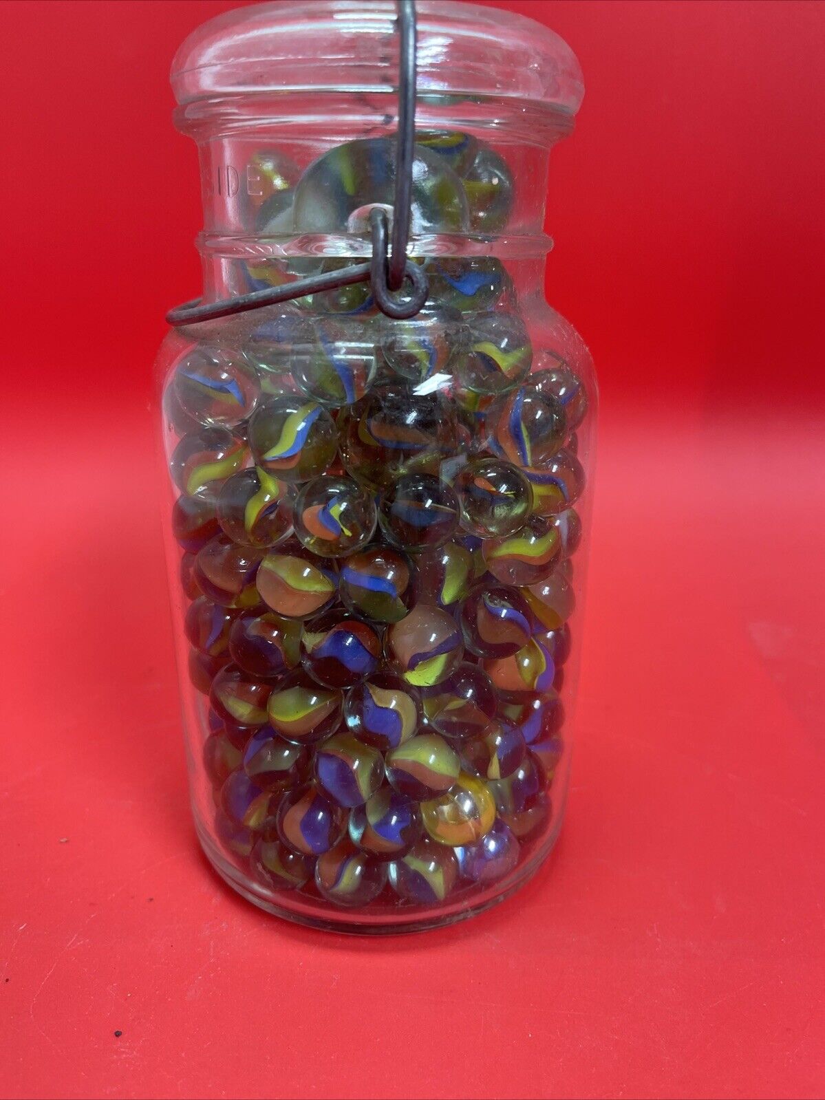 Vintage  Glass Ball Ideal Jar Filled With Marbles.  Jar Is 7” Tall.