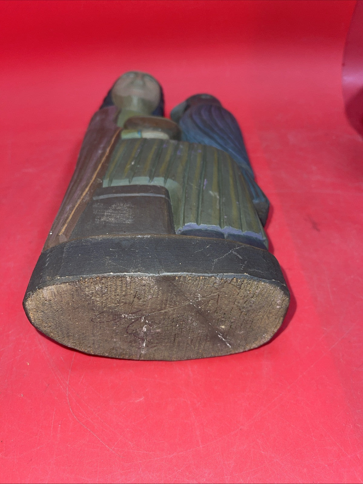 Vintage An ancient folk wood carving depicting a seated figure with a bird.