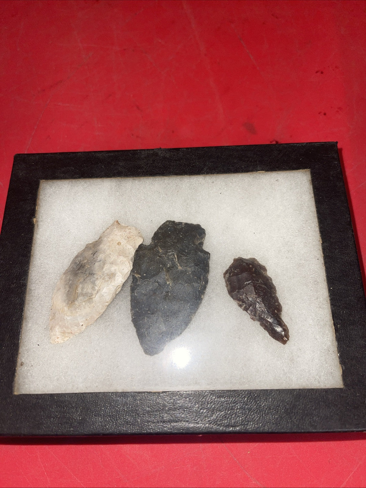 Native American Arrowheads collection in glass case, framed.